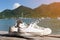 Pair of white sneaker on wooden floor on sea and mountian background