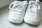 Pair of white sport sneaker shoes on white background.Baby sneakers, running shoes.Children shoes. Moccasins. Baby