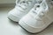 Pair of white sport sneaker shoes on white background.Baby sneakers, running shoes.Children shoes. Moccasins. Baby
