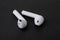 Pair of white wireless earbuds