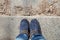 Pair of winter boots on female legs on stairs