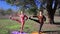 Pair of women exercising yoga fitness sports in forest park.