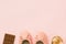 Pair of women`s girl`s ballerina pink pumps flats chocolate tablet perfume bottle on same color background. Female accessories f