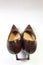 Pair of women`s vintage alligator shoes, rear view, on white, copy space