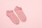 Pair of women socks on pink background