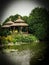 Pair of wooden gazebos by water in park