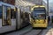 Pair of yellow electric trams entering leaving Victoria Station