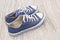 Pairs of canvas blue shoes on the wood background , dirty blue s