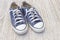 Pairs of canvas blue shoes on the wood background , dirty blue s