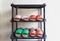 Pairs of home-made traditional wooden shoes on the shoe rack.