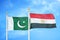 Pakistan and Egypt two flags on flagpoles and blue cloudy sky