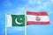 Pakistan and French Polynesia two flags on flagpoles and blue cloudy sky