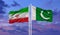Pakistan and Iran flag waving in the wind against white cloudy blue sky together. Diplomacy concept, international relations
