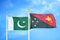 Pakistan and Papua New Guinea two flags on flagpoles and blue cloudy sky