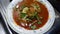 Pakistani cooking mutton dish in a white plate with lemon ginger and coriander food photography