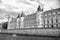 Palace on stone embankment. Boat tour. Palais de la Cite in Paris France. Palace building with towers and spires