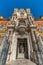 Palacio de San Telmo palace. Wide angle close street level view of main entrance gate and facade detail.