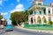 Palacio de Valle, Cienfuegos, Cuba - 30/03/2018: Retro car driving by the palace