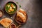 Palak Paneer Indian food, naan bread, rice and spices on a dark background. Top view, flat lay, copy space