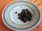 Palak Saag served in a ceramic plate on orange background