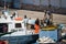 Palamos, Catalonia, may 2016: Fishermen cleaning and repairing m