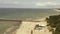 PALANGA, LITHUANIA - JULY, 2019: Aerial view of famous pier of Palanga, sand beach, waves and green pine tree forest.