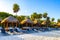 Palapa thatched roofs palms parasols sun loungers beach resort Mexico