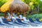 Palapa thatched roofs palms parasols sun loungers beach resort Mexico