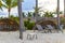 Palapa thatched roofs palms parasols sun loungers beach resort Mexico