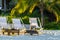 Palapa thatched roofs palms parasols sun loungers beach resort Mexico