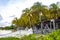 Palapa thatched roofs palms parasols sun loungers beach resort Mexico