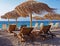 Palapas and lounge chairs on Aigio Beach on the Corinthian Gulf in Greece