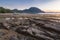 Palawan island, Philippines. El Nido village and mountain at sunset with rocky coastline by low tide in foreground