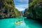 Palawan, Philippines, Travellers Kayaking Exploring El Nido on a Sunny Day