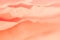 Pale coral red crumpled paper layers background