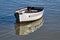 Pale Grey Skiff Reflected in Calm Harbour Waters