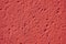 Pale red colorful rough plaster detail, copy space for typing