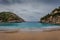 Paleokastritsa bay cliffs and beach with Kolyviri island background on a rainy day