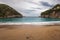 Paleokastritsa beach with Kolyviri island background on a rainy day