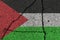 Palestine flag on cracked concrete wall. The concept of crisis, war, conflict, terrorism or other problems in the