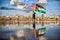 A Palestinian child carrying a flag on the beach