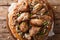 Palestinian dish of chicken with sumac, pine nuts and onions on a flat bread closeup. horizontal top view