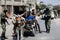 Palestinian fighters with Qassam Brigades, the armed wing of the Hamas movement, distribute protective masks to people amid the Co