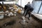 Palestinian men inspects chickens on his farm after winds and rain that lasted for several days, causing the death of a large numb