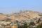 Palestinian village and town separated by wall.