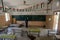 A Palestinian worker wearing a protective face mask sanitises a classroom in school a before a new academic year starts, amid conc