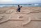 A Palestinian youth writes in sea sand the name of the late Palestinian President Yasser Arafat, to commemorate his death