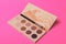 Palette of colorful eye shadows. Pink background