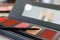 Palette with lip gloss, brush on the table in the beauty salon