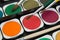 Palette of multicolor watercolor paints with paint brushes